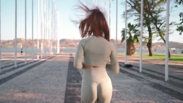 Shot Young Woman Sportswear Confidently Running Summer Park Seaside Back — Stockvideo