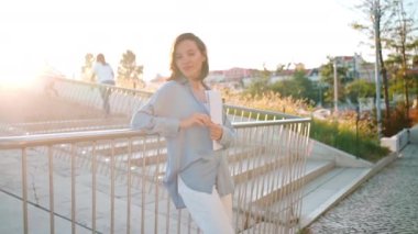 Businesswoman successful woman business person standing outdoor sunny summer day on stairs holding business documentation. Portrait shoot beautiful caucasian female business person with business paper