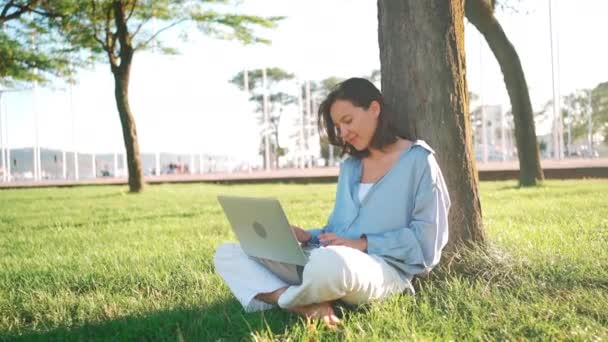 Happy Brunette Woman Using Laptop Computer While Sitting Tree Grass — Wideo stockowe