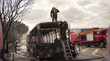 Portugal, Odivelas 07 September 2022 Rescue Team of Firefighters Arrive on the Car Crash fired passenger bus Traffic Accident Scene. Firemen fire department fight with fire on road. Accident disaster