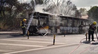 Portugal, Odivelas 07 September 2022 Rescue Team of Firefighters Arrive on the Car Crash fired passenger bus Traffic Accident Scene. Firemen fire department fight with fire on road. Accident disaster