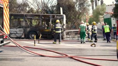 Portugal, Odivelas 07 September 2022 Rescue Team of Firefighters Arrive on the Car Crash fired passenger bus Traffic Accident Scene. Firemen fire department fight with fire on road. Accident disaster