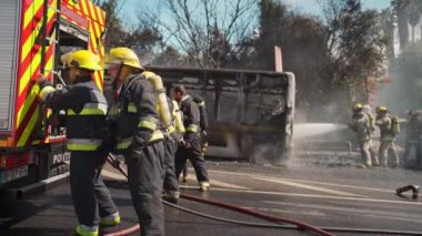 Portugal, Odivelas 07 September 2022 Rescue Team of Firefighters Arrive on the Car Crash fired passenger bus Traffic Accident Scene. Firemen fire department fight with fire on road. Accident disaster