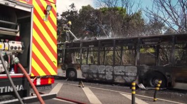 Portugal, Odivelas 07 September 2022 Rescue Team of Firefighters Arrive on the Car Crash fired passenger bus Traffic Accident Scene. Firemen fire department fight with fire on road. Accident disaster