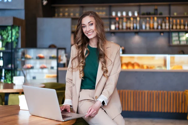 Business Woman Restaurant Owner Use Laptop In Hands Dressed Elegant Pantsuit Sitting On Table In Restaurant With Bar Counter Background Caucasian Female Business Person Indoor