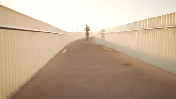 Tracking Shot Young Woman Sportswear Confidently Running Pedestrian Bridge Summer — Stock Video