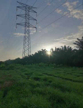 Elektrik iletim kulesinin etrafındaki sabah sahnesi 