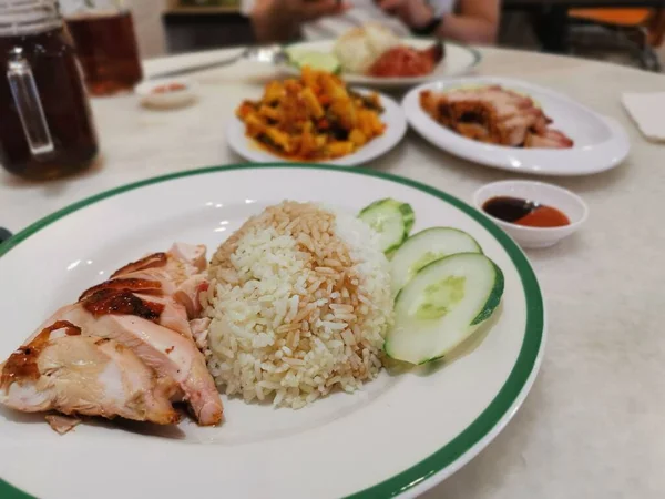 famous chicken rice the staple food of Malaysia with mixed vegetable and crispy sliced fried pork.