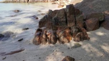 scene of granite boulders by the beach