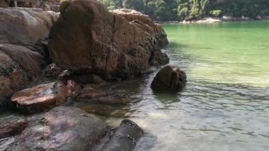 scene of granite boulders by the beach