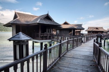 Perak,Malaysia. January 9,2022: Peaceful and quiet daytime scene of the unique architectural wooden houses or villas on stilts by the sea at Pangkor Laut Resort.