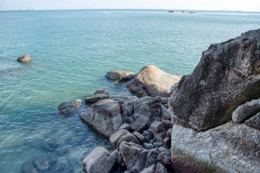 scene of granite boulders by the beach