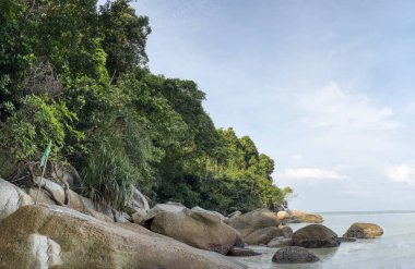 scene of granite boulders by the beach