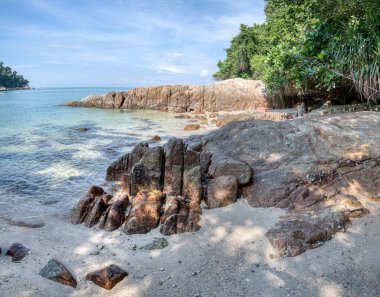scene of granite boulders by the beach