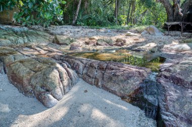 scene of granite boulders by the beach
