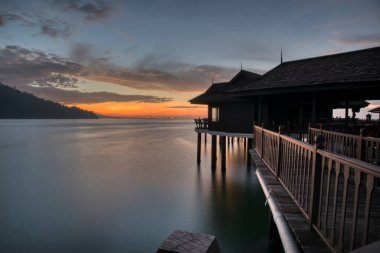 Perak,Malaysia. January 9,2022: Slow exposure shot of the night scene of the unique architectural wooden houses or villas on stilts by the sea at Pangkor Laut Resort.