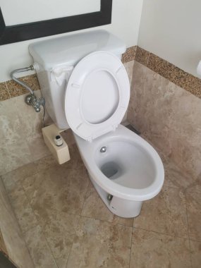 white towel seat with bidet shower.
