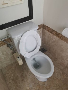 white towel seat with bidet shower.