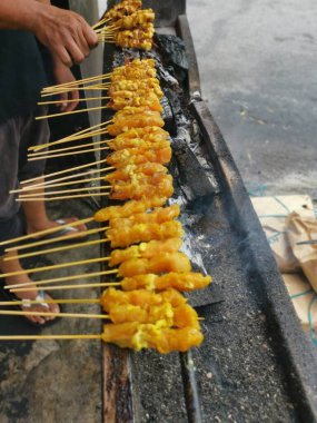 Salamura edilmiş ızgara çubukları ve ısırık büyüklüğünde tavuk eti..