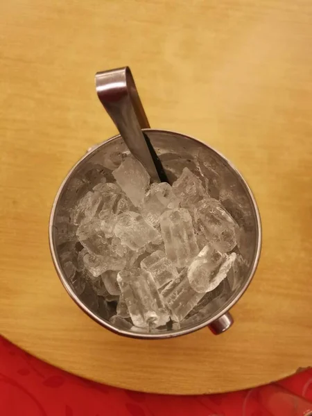 stainless steel jug of ice cubes.