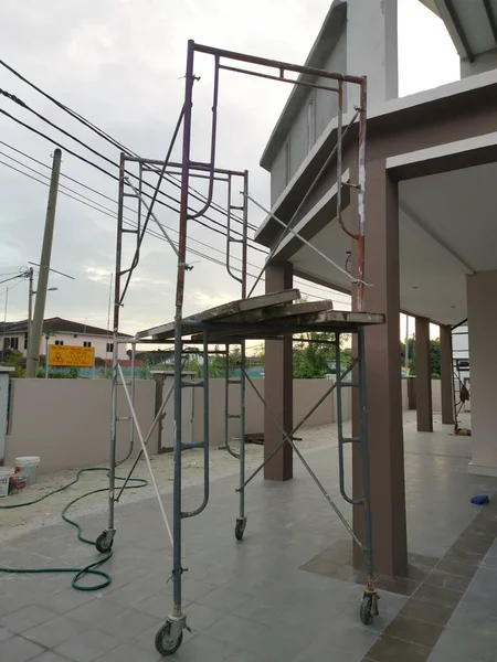 CONSTRUCTION SCAFFOLD Ladder stacked outside the concrete home