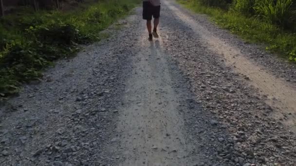 Walking Alone Rough Gravel Rural Road — Stockvideo