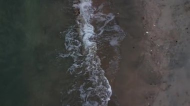 Elevated view of the sea waves moving onto the beach.