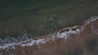 Elevated view of the sea waves moving onto the beach.