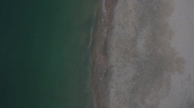 Elevated view of the sea waves moving onto the beach.