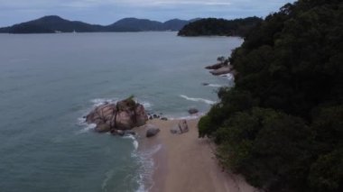 sea waves crashing onto the rocky beach.