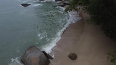 sea waves crashing onto the rocky beach.