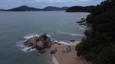 sea waves crashing onto the rocky beach.