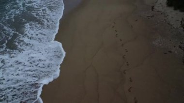sea waves crashing onto the rocky beach.