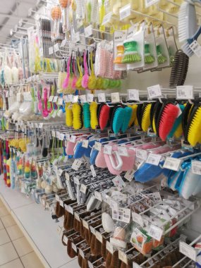 Perak,Malaysia.August 15,2022: Variety of domestic scrub brushes are hanging on shelves for display and sale at Aeon Shopping Supermarket Sri Manjung