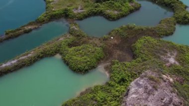 aerial scene of the granite hill looking down on the abandoned mine ponds.