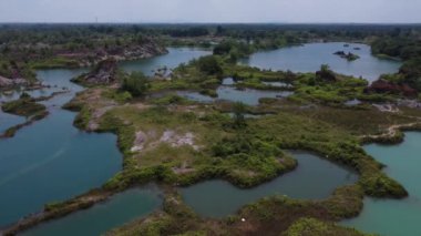 aerial scene of the granite hill looking down on the abandoned mine ponds.