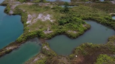 aerial scene of the granite hill looking down on the abandoned mine ponds.