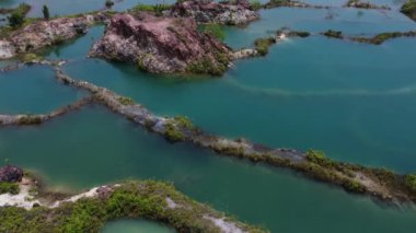 aerial scene of the granite hill looking down on the abandoned mine ponds.