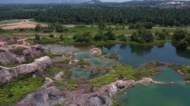 aerial scene of the granite hill looking down on the abandoned mine ponds.