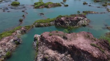 aerial scene of the granite hill looking down on the abandoned mine ponds.