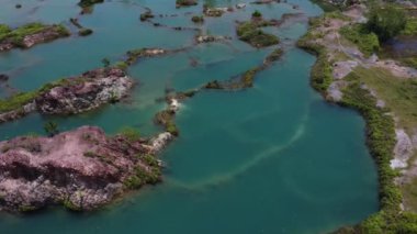 aerial scene of the granite hill looking down on the abandoned mine ponds.