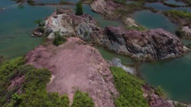 aerial scene of the granite hill looking down on the abandoned mine ponds.