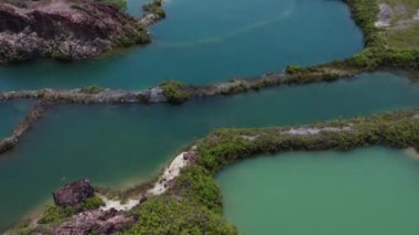 aerial scene of the granite hill looking down on the abandoned mine ponds.