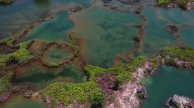 aerial scene of the granite hill looking down on the abandoned mine ponds.
