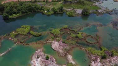 aerial scene of the granite hill looking down on the abandoned mine ponds.