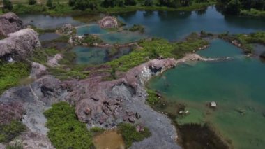 aerial scene of the granite hill looking down on the abandoned mine ponds.