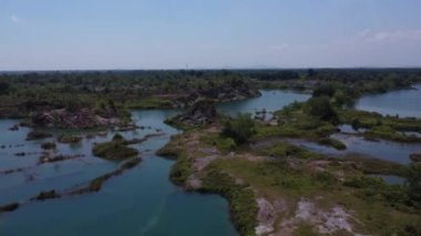 aerial scene of the granite hill looking down on the abandoned mine ponds.