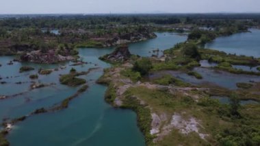 aerial scene of the granite hill looking down on the abandoned mine ponds.