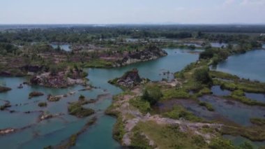 aerial scene of the granite hill looking down on the abandoned mine ponds.