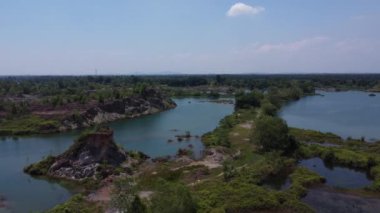 aerial scene of the granite hill looking down on the abandoned mine ponds.